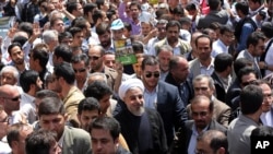 Iranian President Hassan Rouhani, center, joins an annual nationwide pro-Palestinian rally known as Quds (Jerusalem) Day, in Tehran July 25, 2014.
