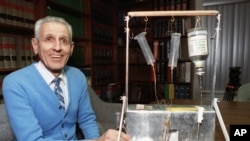Dr. Jack Kevorkian poses with his "suicide machine"