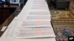A long row of voting tally sheets are lined up in the Senate Press Gallery during a marathon series of votes Dec. 3, 2015, on Capitol Hill in Washington.