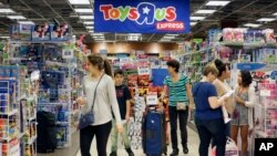 FILE - Shoppers browse at a Toys R Us store in Miami, Nov. 25, 2016. 