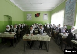 FILE - Class 11 Afghan girl students attend a class at Zarghona high school in Kabul, Afghanistan, Aug. 15, 2015.