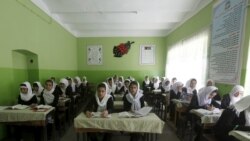 FILE - Class 11 Afghan girl students attend a class at Zarghona high school in Kabul, Afghanistan, Aug. 15, 2015.