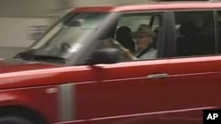 News Corp. CEO Rupert Murdoch, sits reading the last edition of Britain's News of the World tabloid as he arrives at the offices of his U.K. newspaper division in this image taken from TV, July 10, 2011