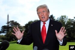 President Donald Trump speaks to reporters on the South Lawn of the White House in Washington, Oct. 9, 2018.