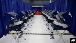 In this March 13, 2018 photo, voters cast their ballots in Illinois elections at the new early voting super site in downtown Chicago. In Illinois, attempts by hackers in the summer of 2016 to alter voter registration information were ultimately unsuccessful.