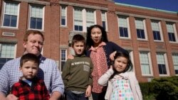 John Horrigan, top left, and his wife Kim Horrigan, top right, stand for a photograph with their children outside Montclair Elementary School, in Quincy, Tuesday, April 13, 2021