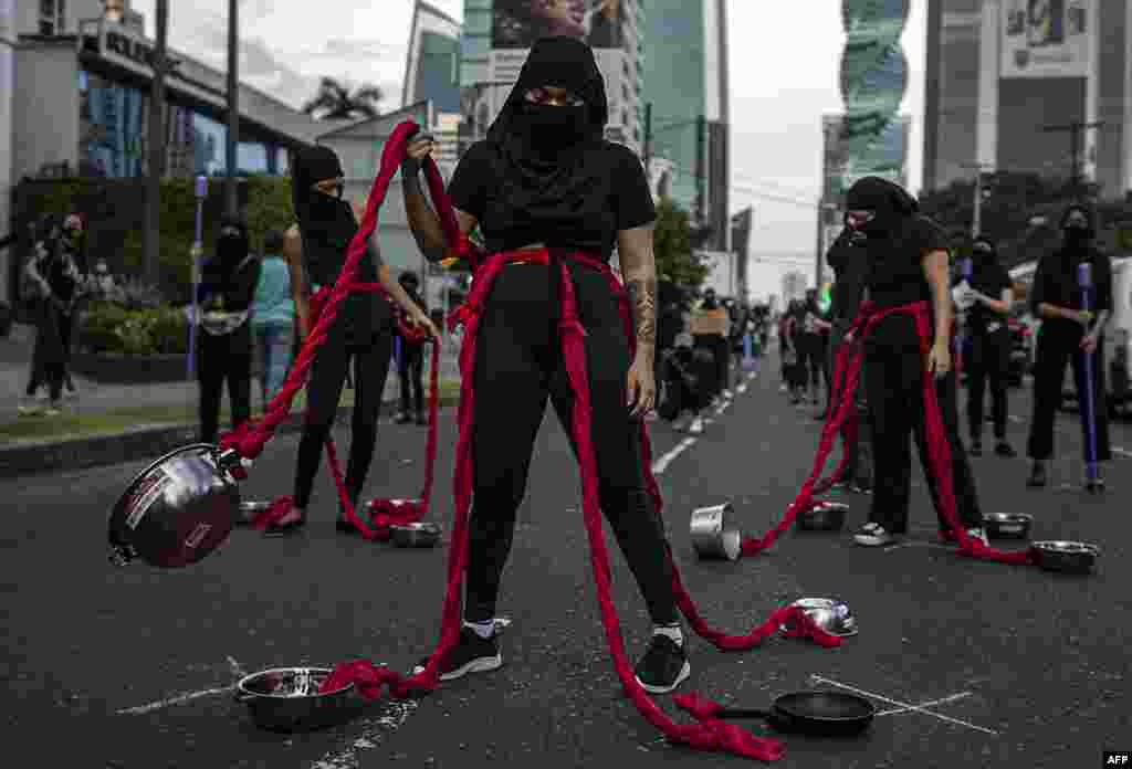 A group of women perform during a protest against the alleged corruption and the lack of measures with a gender perspective, in Panama City, Panama, Sept. 02, 2020.