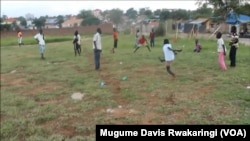 A boy takes a shot at an unseen goal on a barren field in a Juba suburb that South Sudanese children have turned into a field of football dreams.