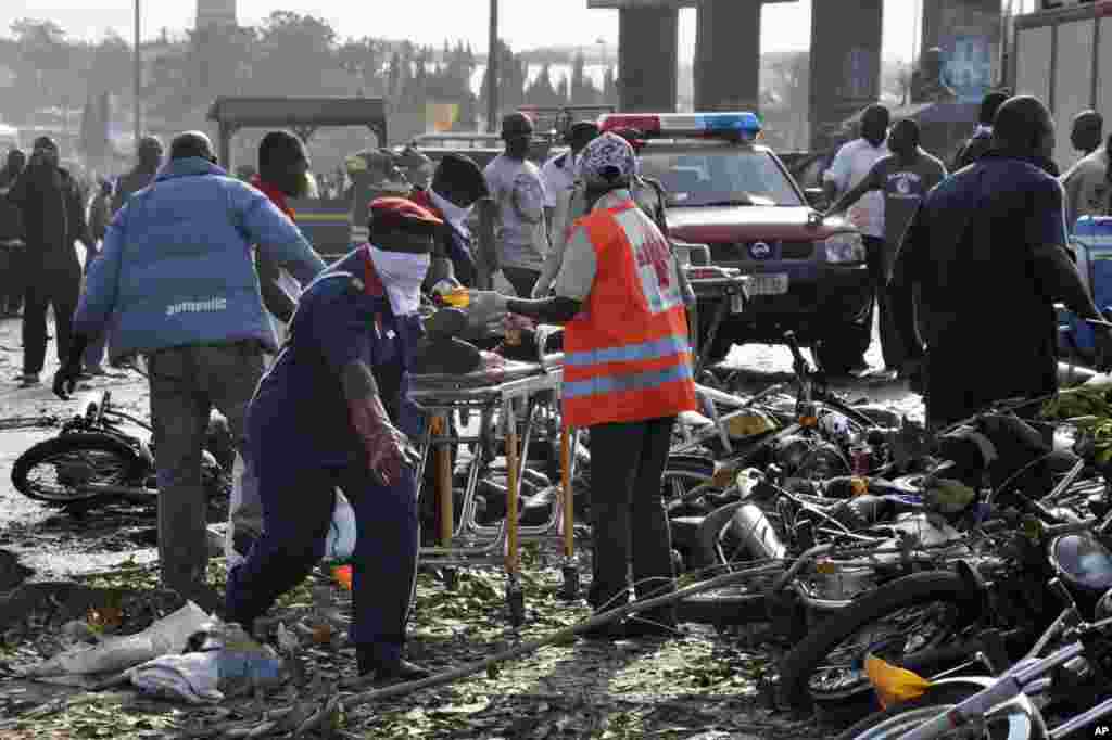 Rescue workers work to recover victims at the site of a blast at the Nyanya Motor Park, about 16 kilometers (10 miles) from the center of Abuja, Nigeria.