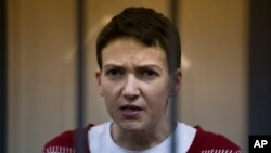FILE - Ukrainian jailed military officer Nadezhda Savchenko listens to the court's decision in a cage at a courtroom in Moscow, Russia, March 4, 2015.
