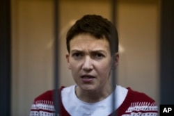 Ukrainian jailed military officer Nadezhda Savchenko listens to the court's decision in a cage at a court room in Moscow, Russia, March 4, 2015.