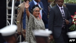 Kenya's first-lady, Margaret Kenyatta - wife of Kenya's President Uhuru Kenyatta - waves to supporters as she arrives in Nairobi on October 20, 2017, for commemorations of Mashujaa (Heroes) Day. (AFP PHOTO / TONY KARUMBA )