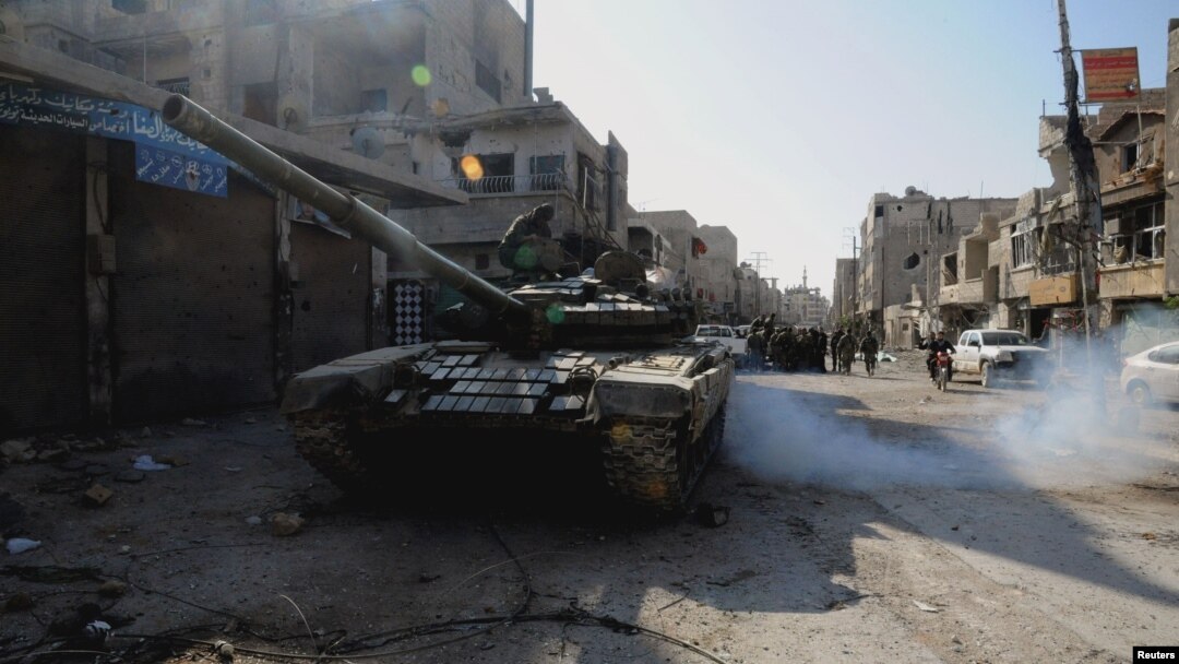 FILE - Soldiers loyal to Syria's President Bashar al-Assad are seen at Hujaira town, south of Damascus, after the soldiers took control of it from the rebel fighters, in this handout photograph distributed by Syria's national news agency SANA, Nov. 13, 2013.