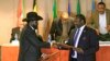The South Sudan government announced on Friday, Aug. 14, 2015, that President Salva Kiir (L), shown here exchanging an earlier peace deal with rebel leader Riek Machar, will not travel to Addis Ababa to attend the latest round of talks to bring peace to his country.