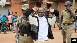 FILE - A supporter of Ugandan pop star-turned-lawmaker Bobi Wine is arrested by security forces during protests in Kampala, Uganda, Aug. 31, 2018. 
