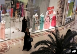 FILE - a shopper strolls through a mall in Riyadh, Saudi Arabia, April 15, 2015.
