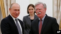 FILE - Russian President Vladimir Putin, left, and U.S. national security adviser John Bolton shake hands during their meeting in the Kremlin in Moscow, Oct. 23, 2018. 