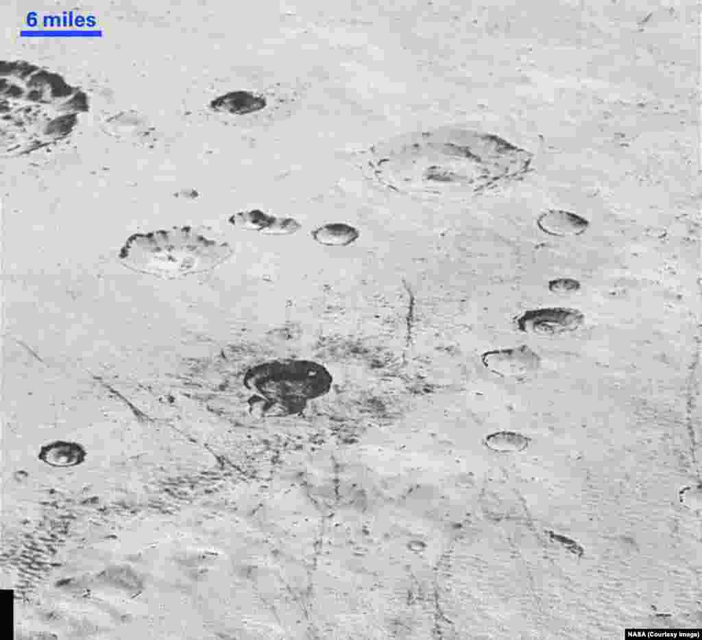 This highest-resolution image from NASA’s New Horizons spacecraft reveals new details of Pluto’s rugged, icy cratered plains, including layering in the interior walls of many craters, released Dec. 4, 2015.