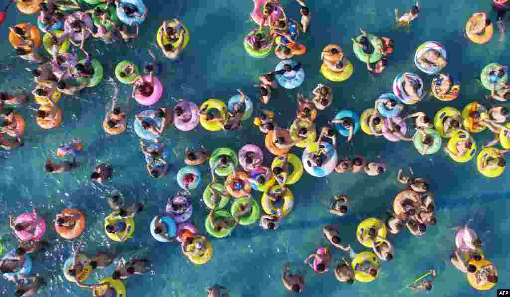 People cool off in a swimming pool in Yangzhou, Jiangsu province, China.