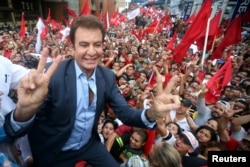 Salvador Nasralla, presidential candidate for the Opposition Alliance Against the Dictatorship, celebrates with supporters while waiting for official presidential election results outside the Supreme Electoral Tribunal in Tegucigalpa, Honduras, Nov. 27, 2