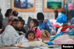 Children who were evacuated from their homes are seen at a evacuation center as tropical storm Pabuk approaches the southern province of Nakhon Si Thammarat, Thailand, Jan. 4, 2019.