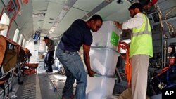 UN workers unload disputed ballot boxes from a FILE - UN helicopter at Kabul International Airport before being transferred to the Independent Elections Commission (IEC) warehouse for auditing, in Kabul, Afghanistan.