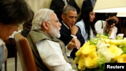 India's Prime Minister Narendra Modi (L) delivers remarks to reporters after meeting with US President Barack Obama (C) in the Oval Office at the White House in Washington, June 7, 2016.