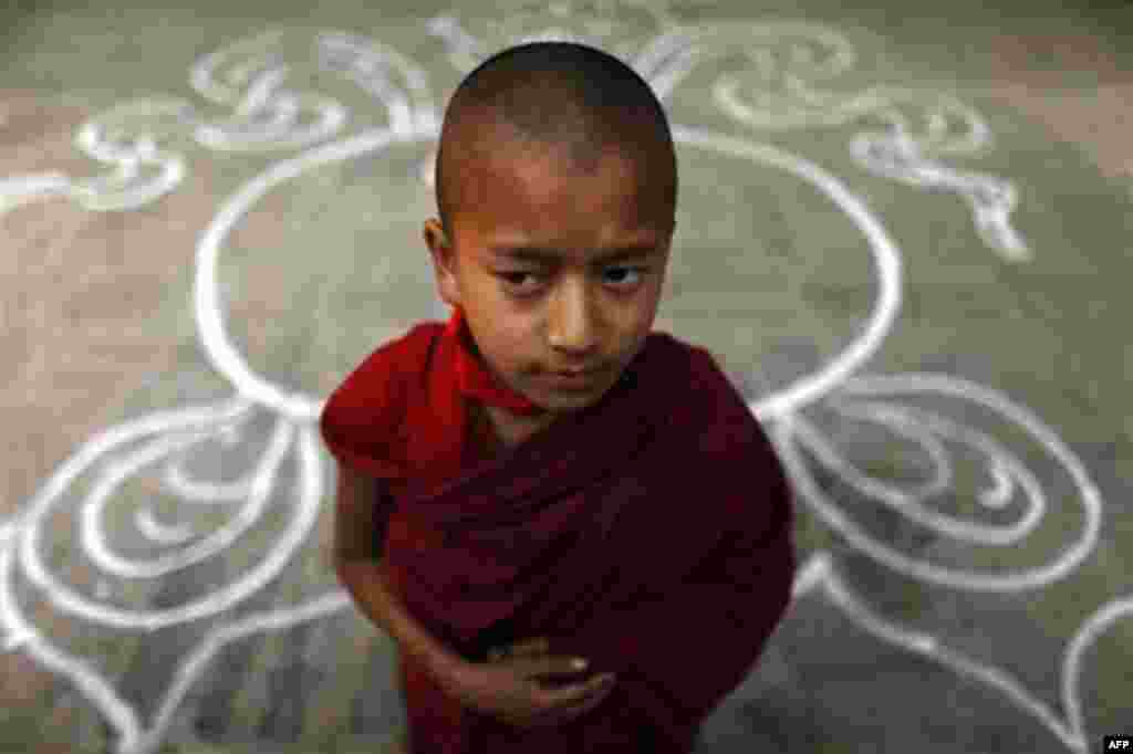 A Tibetan monk stands at a Tibetan Monastery during the third day of "Losar", or Tibetan New Year, at Baudhanath Stupa in Katmandu, Nepal, Friday, Feb. 24, 2012. Tibet's exiled government in India called on Tibetans this year to shun celebrations for thei