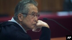 FILE - Peru's jailed, former President Alberto Fujimori, photographed through a glass window, attends his trial at a police base on the outskirts of Lima, Peru, June 28, 2016.