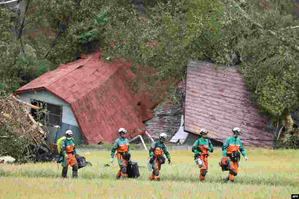 Rescue teams from Tokyo Police search for missing people in Astuma after a 6.6-magnitude earthquake hit the northern Japanese island of Hokkaido.