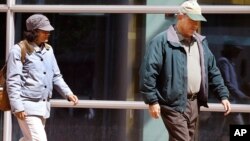 Ana and John Conley, parents of defendant Shannon Conley, exit the U.S. Federal courthouse following their daughter's plea hearing, at the U.S. Federal Courthouse, in Denver, Sept. 10, 2014. 