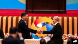 El presidente chino Xi Jinping y el presidente ruso Vladimir Putin se dan la mano durante el Foro de la Franja y la Ruta en el Gran Palacio del Pueblo en Beijing, el miércoles 18 de octubre de 2023.