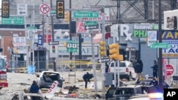 Investigators work the scene after a small plane crashed in Philadelphia, Feb. 1, 2025. 