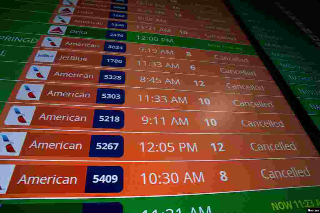 An information screen is seen at Ronald Reagan Washington National Airport, in the aftermath of the collision of American Eagle flight 5342 and a Black Hawk helicopter that crashed into the Potomac River, in Arlington, Virginia, Jan. 30, 2025. 