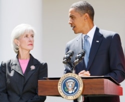 FILE - President Barack Obama stands with Health and Human Services Secretary Kathleen Sebelius as he makes a statement on the H1N1 swine flu virus in the Rose Garden of the White House in Washington, Sept. 1, 2009.