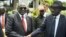 South Sudan's First Vice President Riek Machar, left, and President Salva Kiir, right, shake hands following the first meeting of a new transitional coalition government, in the capital Juba, April 29, 2016. 