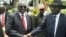 South Sudan's First Vice President Riek Machar, left, and President Salva Kiir, right, shake hands following the first meeting of a new transitional coalition government, in the capital Juba, April 29, 2016. 