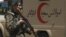 An Afghan soldier patrols outside a hospital in Kabul