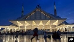 People visit the Faisal Mosque in Islamabad, Pakistan, on Aug. 25, 2023. Pakistanis are protesting increased taxes on electricity bills.