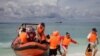 FILE - Chinese tourists disembark from an inflatable boat upon arrival in Quanfu island, a Paracels of Sansha prefecture of China's Hainan province. 