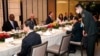 FILE - China's then-Defense Minister, Gen. Wei Fenghe, center right, talks with U.S. Secretary of Defense Lloyd Austin, left, during the 19th International Institute for Strategic Studies (IISS) Shangri-la Dialogue in Singapore, June 11, 2022.