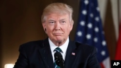 President Donald Trump listens during a joint news conference with German Chancellor Angela Merkel in the East Room of the White House in Washington, March 17, 2017.