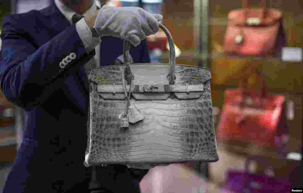 An employee holds an Hermes diamond and Himalayan Nilo Crocodile Birkin handbag at Heritage Auctions offices in Beverly Hills, California, Sept. 22, 2014.