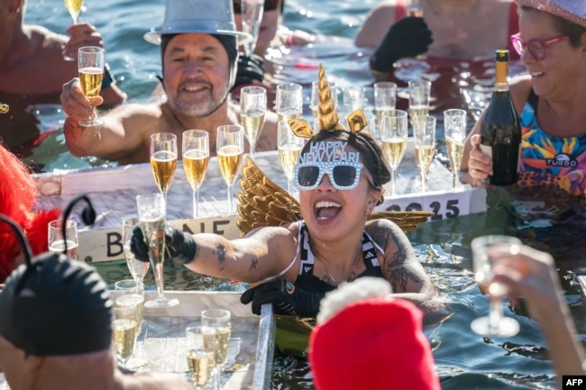 Revelers take part in a New Year's day swim in Lake Geneva with its 7.3 degree celsius waters in Geneva, Switzerland, Jan. 1, 2025.