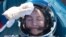 FILE - NASA astronaut Jessica Meir rests after landing in a remote area outside of Dzhezkazgan, Kazakhstan, April 17, 2020. Two NASA astronauts and a Russian cosmonaut had been aboard the International Space Station.