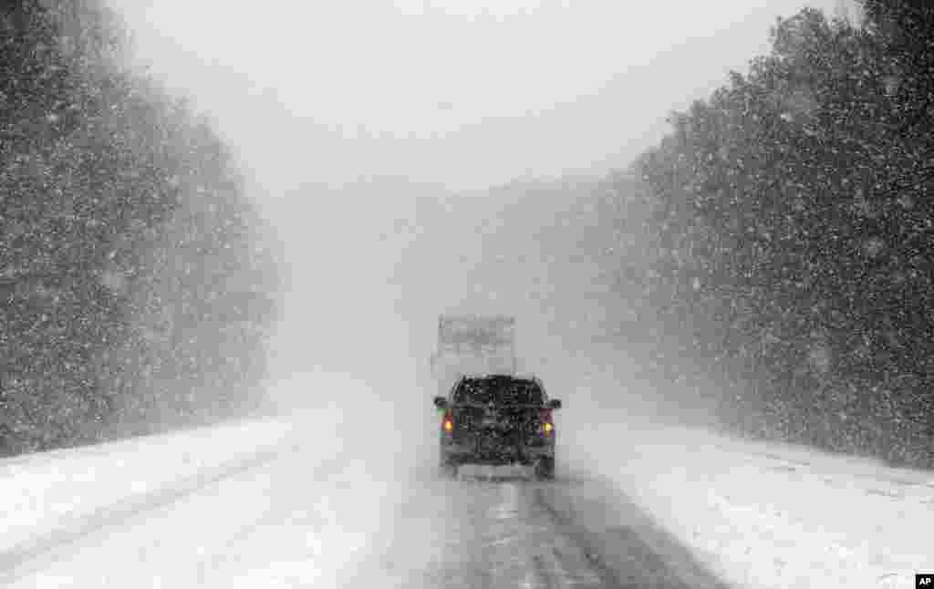 Vehicles move along a snow and ice covered Interstate 26, near Savannah, Ga., Jan. 3, 2018.