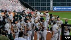 The Oakland Athletics walk off the field before playing the Houston Astros as both teams elected not to play in protest of racial injustice in Houston, Texas. Professional and college athletes across the nation took part in the protest.