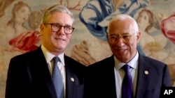 Britain's Prime Minister Keir Starmer, left, poses with European Council President Antonio Costa as he arrives for an EU summit at the Egmont Palace in Brussels, Monday, Feb. 3, 2025. 