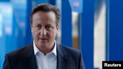 Britain's Prime Minister David Cameron returns to his hotel after giving radio interviews on the third day of the Conservative Party Conference in Birmingham, central England, Sept. 30, 2014. 