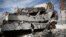 Men walk on the rubble of the Chamber of Trade and Industry headquarters after it was hit by a Saudi-led airstrike in Sanaa, Yemen, Jan. 5, 2016. 